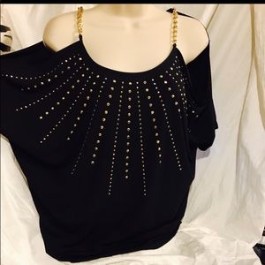 Black bare shoulder blouse with gold studs for design.